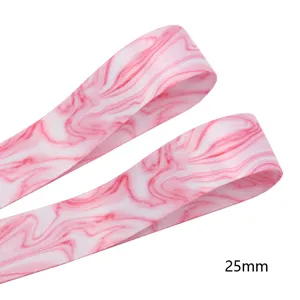 Close-up detail of pink marble printed double-sided ribbon, 25mm width texturing.