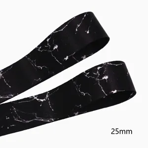 Close up detail of 25mm black marble printed double face ribbon, smooth texture fabric trim.