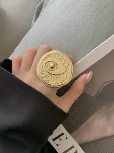 Gold plated statement ring with surrealist eye relief design, bold chic fashion jewelry.