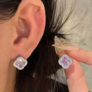 Exquisite four-petal flower cubic zirconia earrings with stunning purple center stone design.