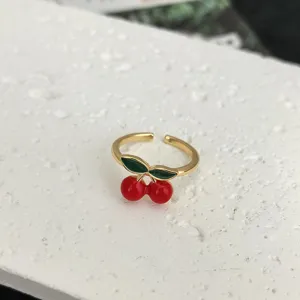 Gold-colored adjustable open ring featuring cute red cherry and green leaf enamel design.