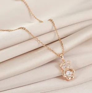 Rose gold dancing bear necklace with micro-set cubic zirconia, elegant clavicle chain.