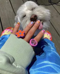 Resin orange flower and pink heart ring detail view, stylish cute fashion accessory.