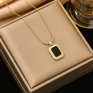 Gold-plated rectangular pendant necklace with black center and sparkling zircon stones.