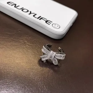 Close-up detail of a sparkling crystal bow ring featuring brilliant zirconia stones.