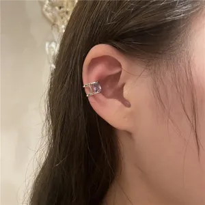 Detail shot of a minimalist C-shaped ear cuff with purple zircon, elegant design for non-pierced ears.