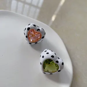 Heart-shaped rings with cow print and colorful gemstone center, stylish and trendy jewelry accessory.