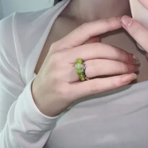 Handmade green stone beaded ring with unique lava open band design shown in detailed shot.
