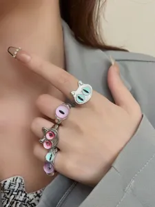 Detailed shot of stackable metal rings featuring unique cat eye glass designs for women.