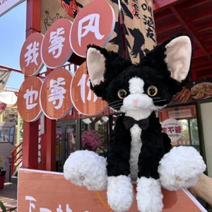 Simulation black and white Devon Rex cat plush toy, cute curly kitten doll gift for kids.