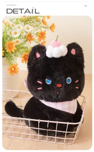 Close-up of cute black cat plush toy with cherry cream hat and pink plaid bib, cozy detail view.