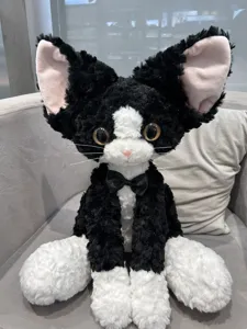 Cute black and white Devon Rex cat plush toy with big ears and bow tie for kids and home decor.