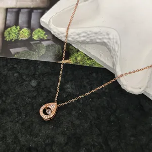 Rose gold teardrop dancing stone necklace detail, elegant zirconia clavicle chain jewelry.