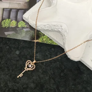 Rose gold heart key pendant necklace, exquisite clavicle chain, minimalist daily jewelry style.