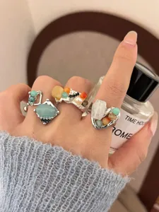 Closeup detail view of handmade natural stone gemstone opening stacked rings for women.