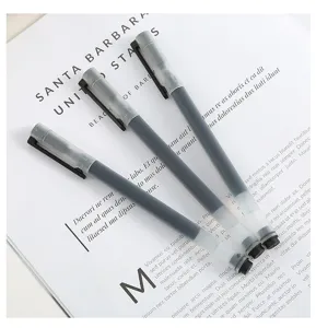 Close-up shot of transparent gel pens with black ink, minimalist stationery detail view.