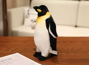 Cute emperor penguin plush toy detail view, soft stuffed animal doll with fine texture.