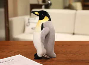 Detailed view of a cute plush penguin toy, soft emperor penguin stuffed animal doll for kids.