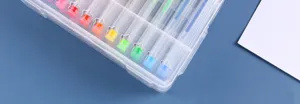 Close-up detail of colorful glitter gel pens in a transparent box, perfect for stationery.