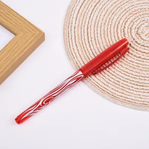 Détail de stylo gel effaçable rouge avec motif coloré, capuchon transparent et gomme pratique.