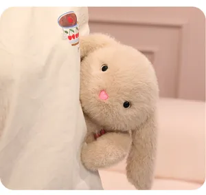 Cute plush rabbit toy detail shot, soft furry stuffed animal doll with adorable peeking design.
