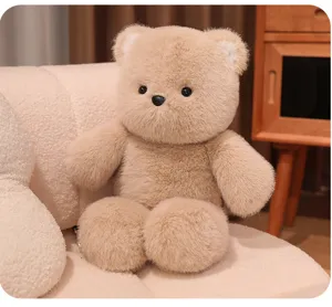 Cute fluffy brown teddy bear plush toy sitting on cozy sofa, soft stuffed animal doll.