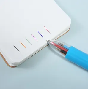 Multi-color retractable ballpoint pen writing lines on notepad, colorful student stationery detail.