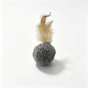 Detailed close-up view of grey plush cat toy ball with natural feathers for active play.