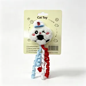 Close-up of cute plush cat toy with baseball cap, catnip inside and colorful ribbons.