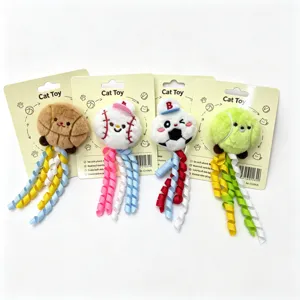 Cute plush cat toy detail showing four sports ball designs with colorful ribbons and backing cards.