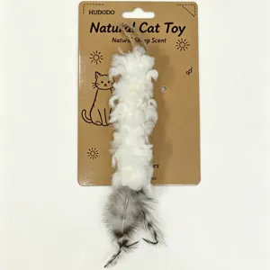 Detailed view of natural wool and feather cat toy, hanging on packaging card showing sheep scent.