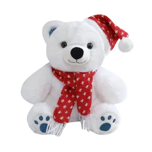 Joli jouet en peluche ours polaire blanc avec bonnet de Noël et écharpe rouge douce.