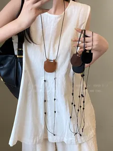 Magnetic leather sunglasses holder necklace for women, portable glasses lanyard accessory.