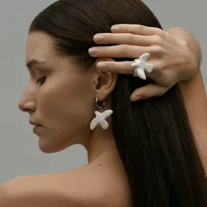 Elegant white ceramic peace dove ring and matching hoop earrings set for women fashion jewelry styling.