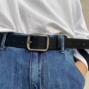 Minimalist black leather belt with metal pin buckle for casual jeans outfits detail view