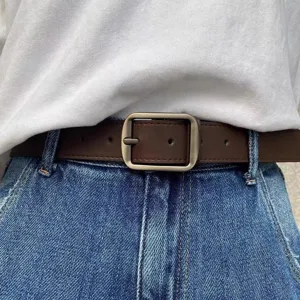 Detailed close-up shot of dark brown leather belt featuring a classic square metal buckle.