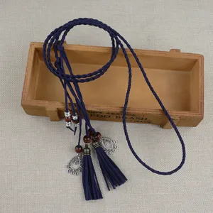 Detailed view of the dark blue braided tassel belt with wooden beads, ethnic style decor.