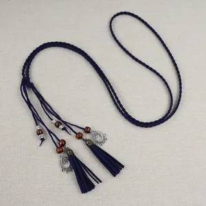 Detailed view of the dark blue braided waist chain with wooden beads and tassel pendants.
