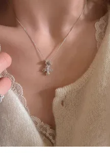Delicate silver clavicle necklace with sparkling rhinestone vajra cross pendant for women.