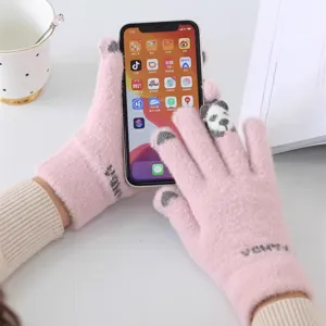 Close-up of pink knit touchscreen gloves featuring cute panda pattern detail for winter.