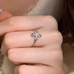Silver cross ring with sparkling small crystal stones, elegant finger jewelry for women.