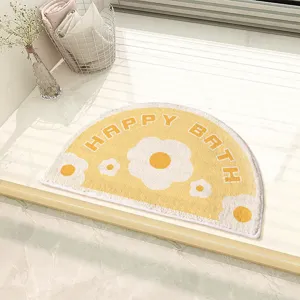 Absorbent semi-circular bathroom mat with cute flower pattern and anti-slip backing for home.