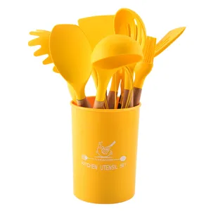 Yellow silicone kitchen utensil set with wooden handles and storage holder for cooking.