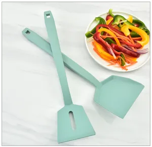 Silicone kitchen spatula set, light green cooking tools, heat-resistant utensil detail view.