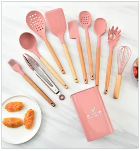 Detailed view of the 10-piece pink silicone kitchen utensil set with wooden handles and storage holder.
