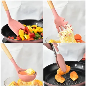 Pink silicone kitchen utensil set with wooden handles, spatula, ladle, and tongs for cooking.