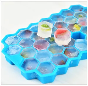 Detail view of hexagonal silicone ice cube tray filled with colorful fruit ice cubes.