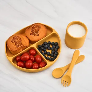 Baby silicone feeding set with divided plate, cup, spoon, and fork for toddlers and kids.
