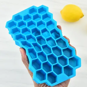Silicone honeycomb ice cube tray mold, flexible blue kitchen gadget for homemade ice drinks.