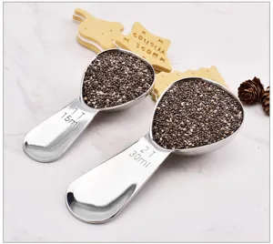 Stainless steel measuring spoon detail shot showcasing 15ml and 30ml scale markings for baking.